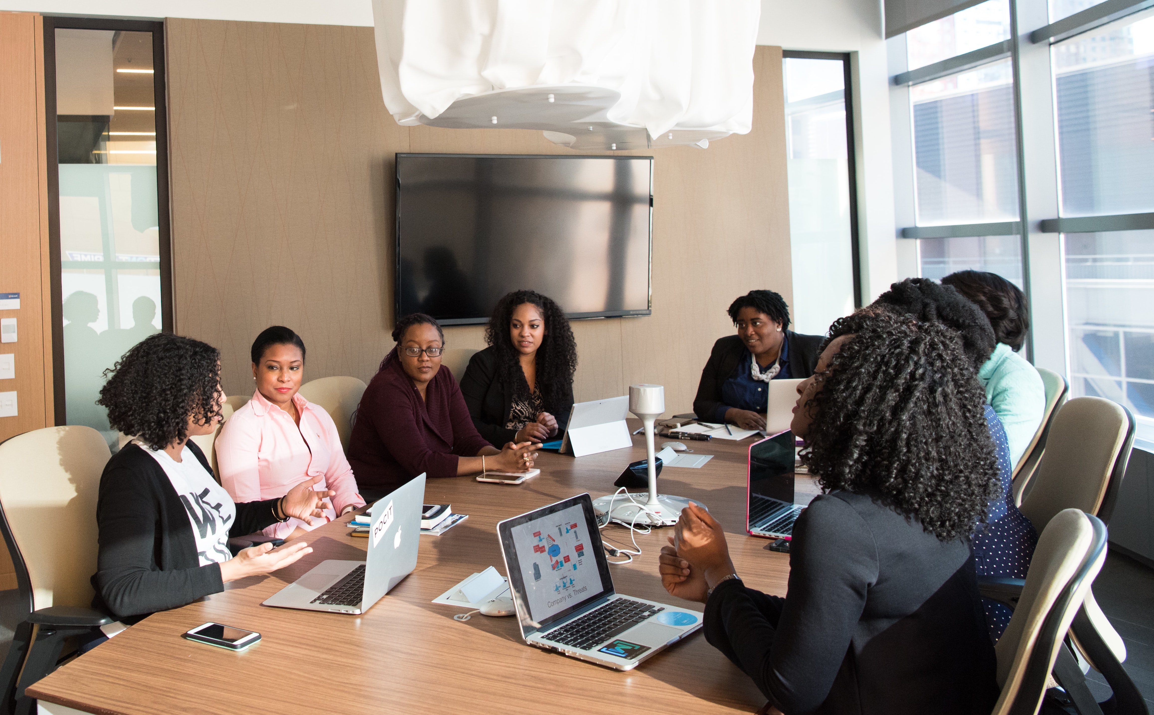Black Women sitting around a conference table
